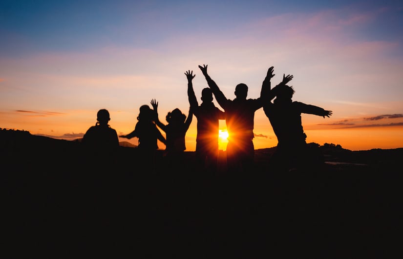 Silhouette Of People Raising Hands During Golden Hour